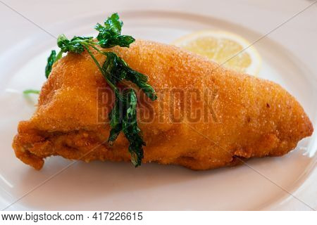 Viennese Fried Chicken Breast With Lemon Wheel And Fried Parsley