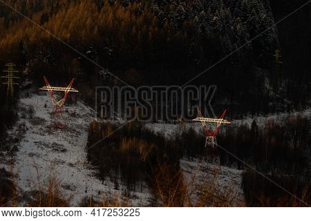 Power Lines In Forest In Sunset Light.