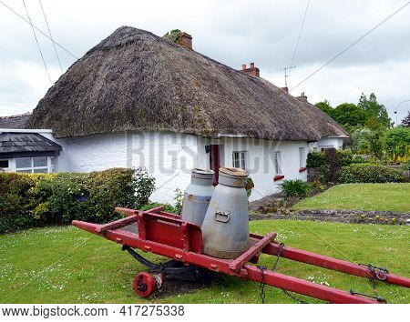ADARE, IRELAND - MAY 17, 2011: The thatched roof cottage with whitewashed walls is a powerful symbol of Ireland. 