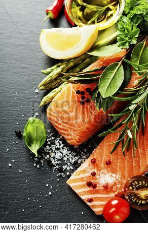 Delicious  Portion Of Fresh Salmon Fillet  With Aromatic Herbs, Spices And Vegetables - Healthy Food