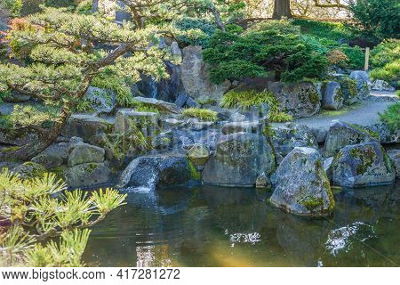 A Gond  With Rocks At A Botanical Garden In Seatac, Washington.