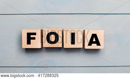 Wooden Cubes With The Text Foia The Freedom Of Information Act On A Light Blue Wooden Background.