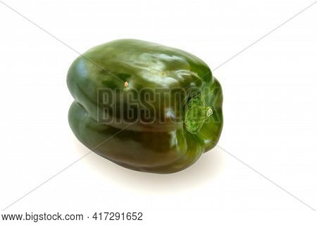 Nonideal Green Bell Papper With Speckles, Laying On A Flat Surface, Isolated On A White Background. 