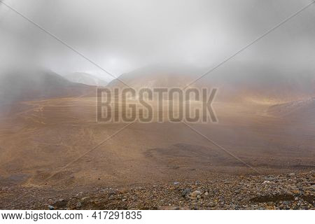 Through The Mist, Tongariro Alpine Walk Expansive Flat Scoria Plain Stretching Out Ahead. New Zealan