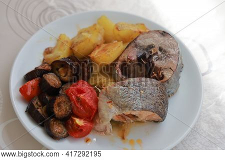 Two Pieces Of Fish With Stewed Vegetables On A Plate, Turkish Salmon And Palamut