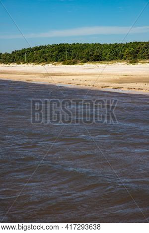 Sand And Vegetation With Blue Sky