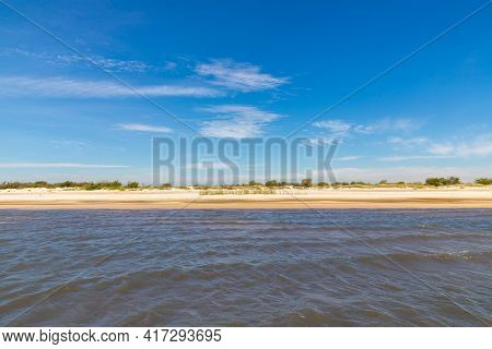 Sand And Lake With Blue Sky