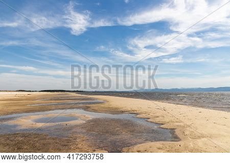 Sand And Lake With Blue Sky