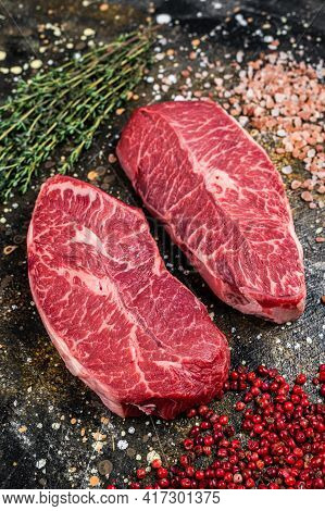 Raw Shoulder Top Blade Cuts, Beef Meat Steaks. Brown Background. Top View