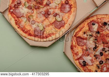 Pizza In Brown Corrugated Fiberboard Take-out Box On Coloredbackground. Round, Pizza