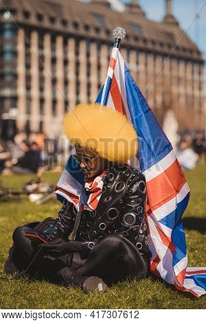 Westminster, London | Uk -  2021.04.17: Beautiful Stylish Person Waving The Union Jack Flag At The K