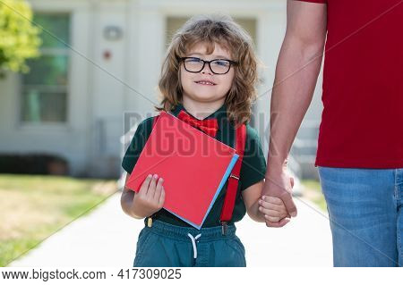 Father And Son Holding Hand After Come Back From School.
