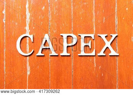 Alphabet Letter In Word Capex (abbreviation Of Capital Expenditure) On Old Red Color Wood Plate Back