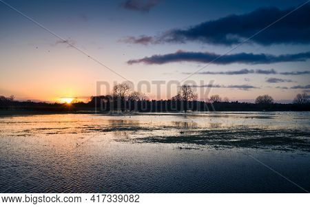 Flooded Field At Sunset Landscape. Field Under Floodwater After Rain In Buckinghamshire, Uk