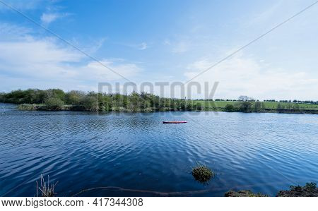 Landscape View With River And Blue Sky And Cloudty On Spring. Panoramic Of Green Grass Fields At Far