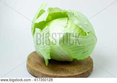 Cabbage On A White Background. Head Of Cabbage On A Light Background. Fresh Young Cabbage