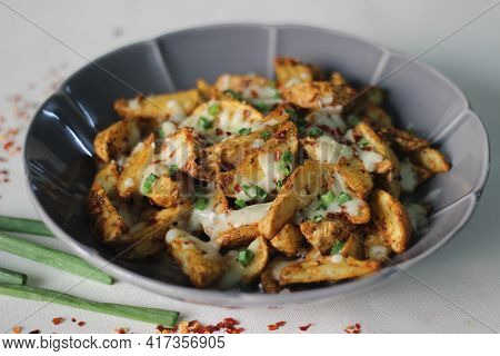 Cheesy Potato Wedges Made By Baking Air Fried Potato Wedges After Sprinkling It With Shredded Mozzar