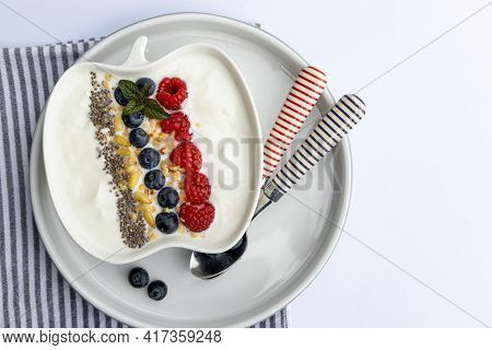 Fresh Yogurt With Fruits, Granola, Chia Seeds Und Napkin