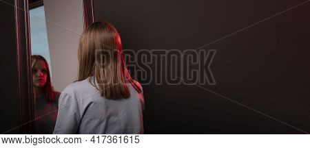 Young Woman Looking At Her Mirror Reflection With Grief. Unhappy Sad Person. Psychological Concept O