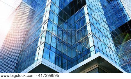 Bottom View Of Modern Skyscrapers In Business District Against Blue Sky. Looking Up At Business Buil