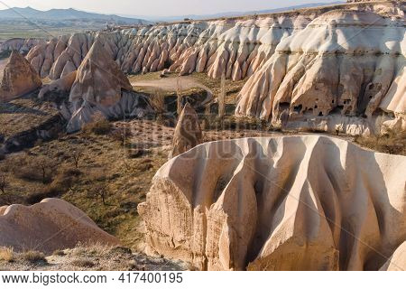 Volcanic Rock Formations With Acient Houses Inside And Fairy Chimneys In Cappadocia