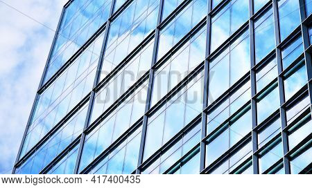 Abstract Closeup Of The Glass-clad Facade Of A Modern Building Covered In Reflective Plate Glass. Ar