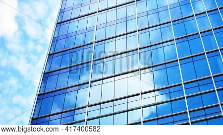 Abstract Closeup Of The Glass-clad Facade Of A Modern Building Covered In Reflective Plate Glass. Ar