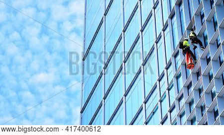 Abstract Closeup Of The Glass-clad Facade Of A Modern Building Covered In Reflective Plate Glass. Ar