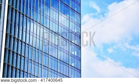 Abstract Closeup Of The Glass-clad Facade Of A Modern Building Covered In Reflective Plate Glass. Ar