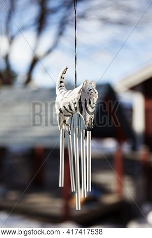 A Wooden Figure Representing A Cat Used For A Wind Chime