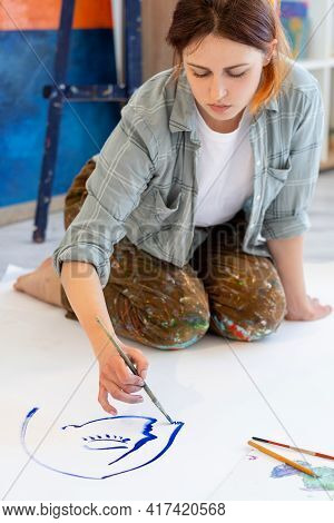 Painting Hobby. Contemporary Art. Visual Illustration. Female Artist In Stained Clothes Drawing Blue