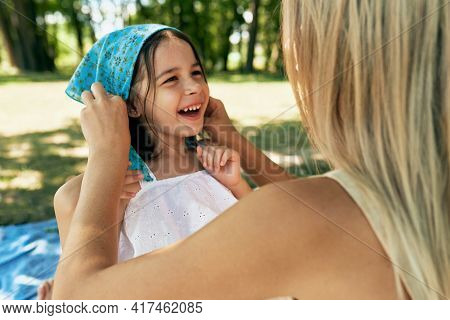 Cheerful Smiling Daughter Playing With Her Mother In Sunny Summer Day In The Park. Kid And Youmg Wom