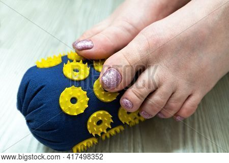 Womens Feet Stand On A Needle Roller - Foot Massage Using An Applicator Kuznetsov, Russia