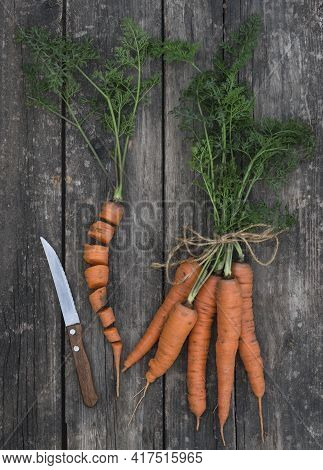 Carrots And Knife On A Wooden Background.
