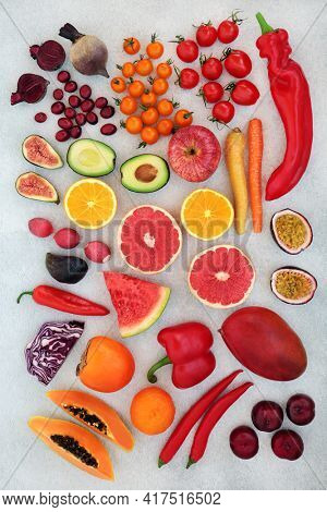 Healthy super foods high in lycopene and anthocyanins for good heart health also high in antioxidants, vitamins, minerals. omega 3 and dietary fibre. With fruit and vegetables. On mottled grey.