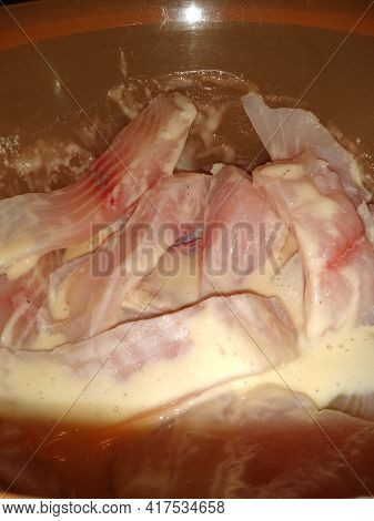 The Process Of Cooking Fish In Batter Close-up. High Quality Photo