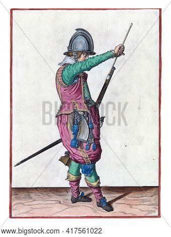 A soldier, full-length, to the right, holding a rudder (a certain type of firearm) with his left hand by his left thigh and pulling the ramrod from the holder under the barrel with his right hand