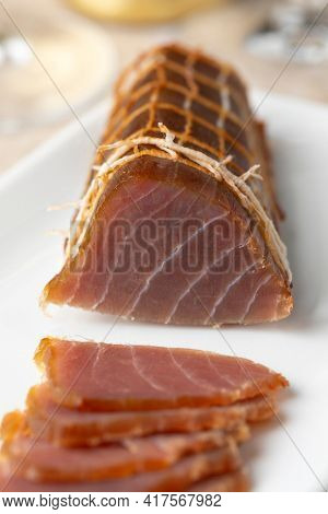 Piece of  cold smoked Albacore tuna fish and slices close up