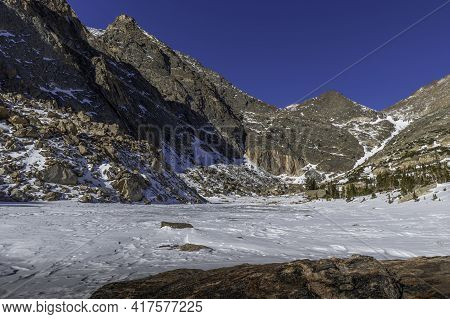 The Jagged Peaks Of Ypsilon Mountain Tower Over Upper Fay Lake