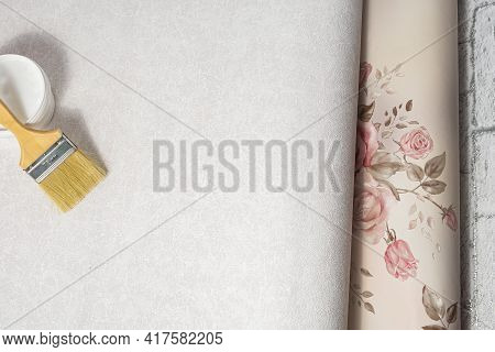 Patterned And Patternless Paper Wallpapers, Brush And Glue Are Prepared For Renovation In The Apartm