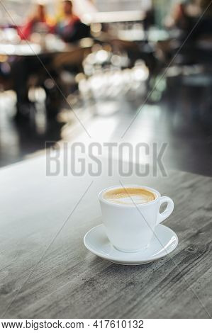 Cup Of Coffee With Latte Art On Rustic Wooden Table In A Streer Cafe. Place For Text.