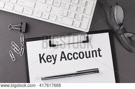 Office Paper Sheet With Text Key Account With Office Tols And Keyboard. Business Concept