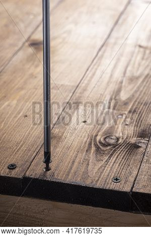 A Screwdriver And Screw On A Wooden Background. Screwdriver Of Chromium Vanadium Steel. Construction
