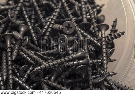 A Handful Of Self-tapping Screws For Wood. Construction Abstraction. Industrial Background.