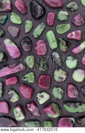 Ruby Zoisite Rare Jewel Stones Texture On Black Stone Background.