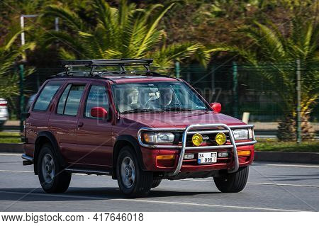 Antalya, Turkey - April 12 2021:  Red Nissan Terrano  Is Driving Fast On The Street On A Warm Summer