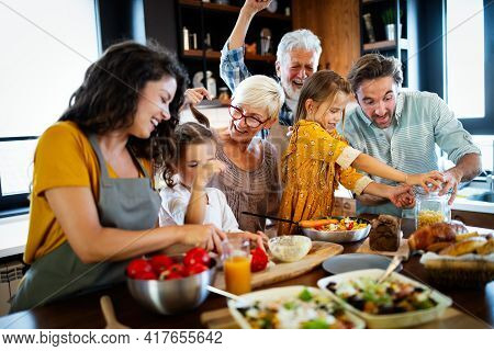 Cheerful Family Spending Good Time Together While Cooking In Kitchen