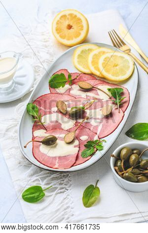 Vitello tonnato - Italian cuisine, sliced veal with tuna sauce as antipasto with capers
