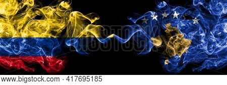 Colombia, Colombian Vs Kosovo, Kosovar Smoky Mystic Flags Placed Side By Side. Thick Colored Silky A