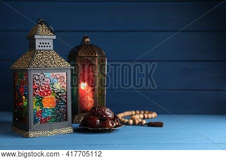 Arabic Lanterns, Dates And Misbaha On Wooden Table. Space For Text